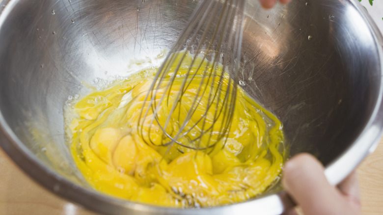 Eggs being whisked in a bowl