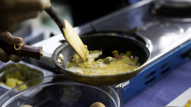 Eggs scrambled with vegetables in a pan