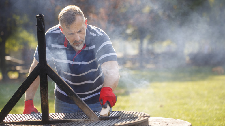 Man cleaning a grill