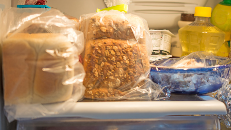 fridge shelf with loaves of bread