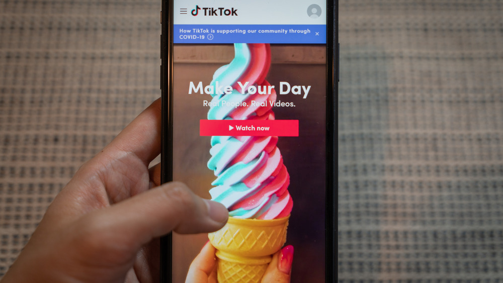 Phone with TikTok app on screen