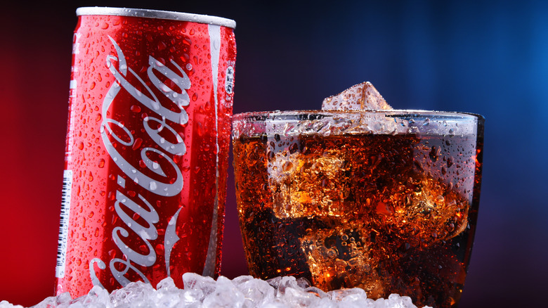 Coca-Cola can in glass on ice