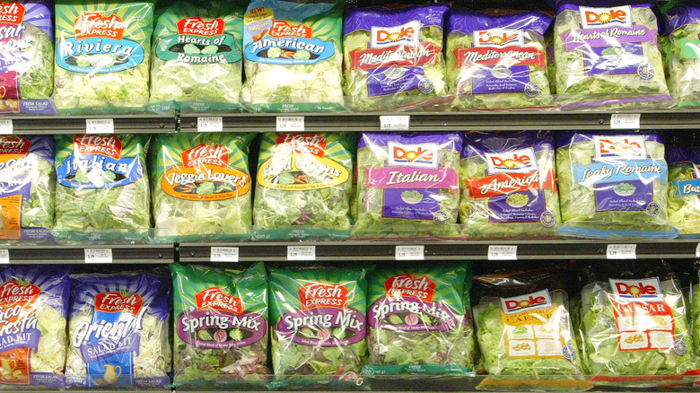 Shelves of bagged lettuce