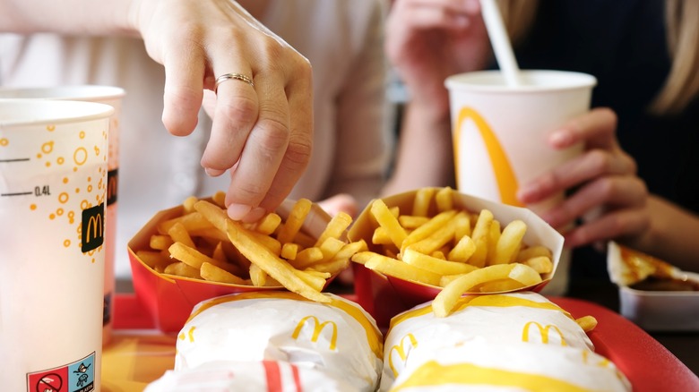 Hand grabbing fries at McDonald's