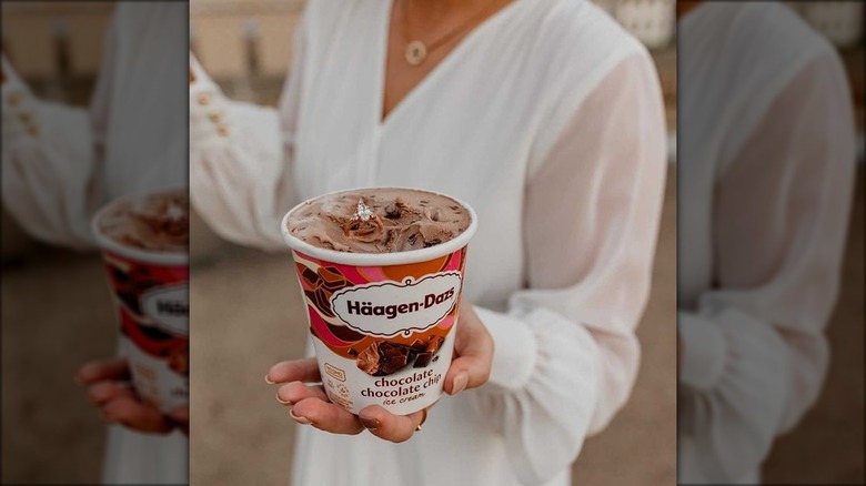 Woman holding tub of chocolate ice cream