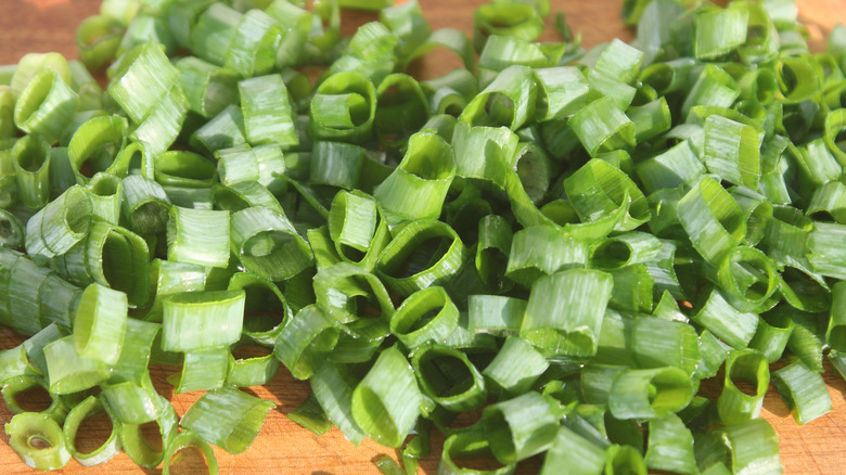 Chopped green onions on cutting board