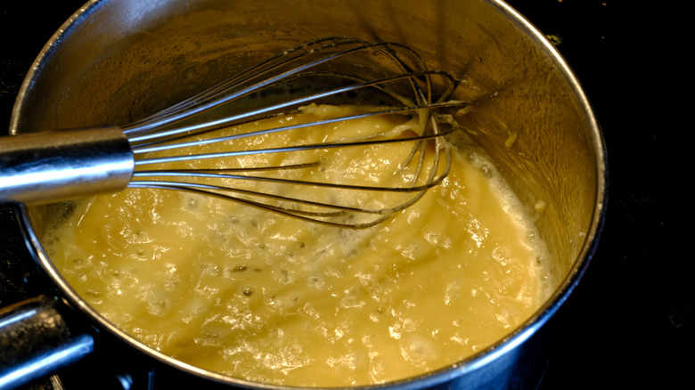 Pot with roux and whisk 