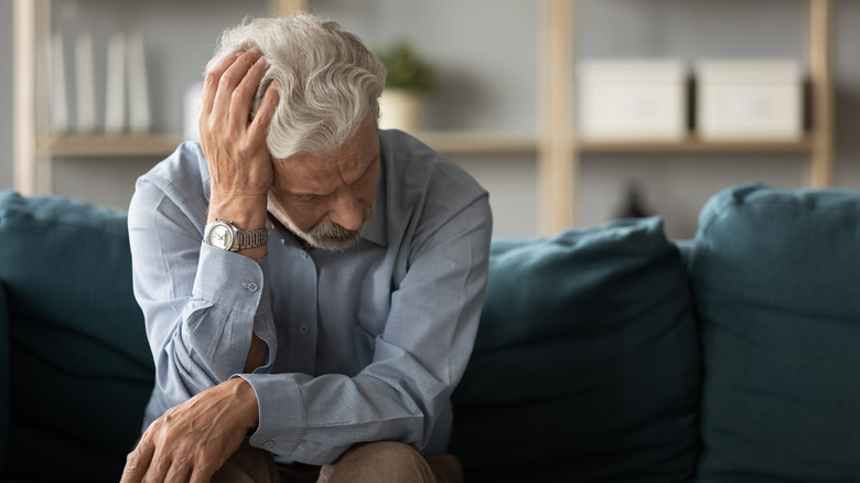 sad older man on couch