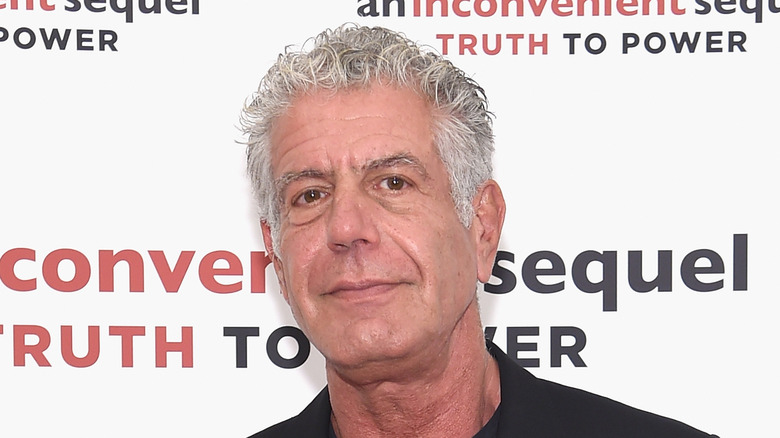 anthony bourdain posing for photo