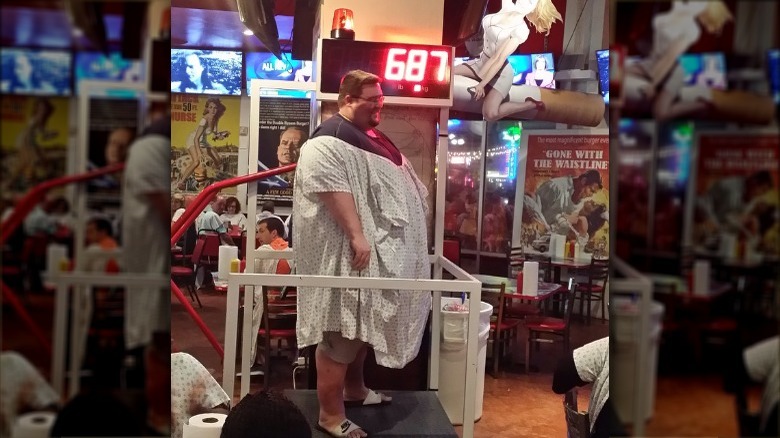 A customer weighing himself in Heart Attack Grill