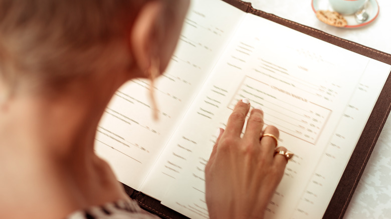 Woman reading a restaurant menu
