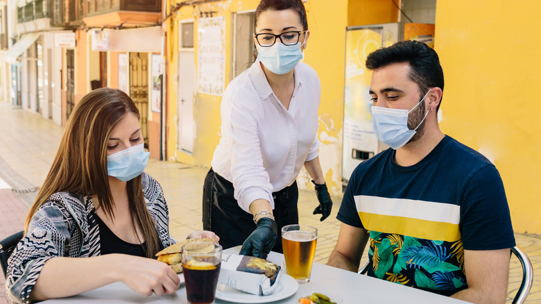 Server wearing mask and gloves