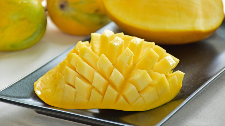 yellow honey mangoes halved and cut with a cross-hatch pattern