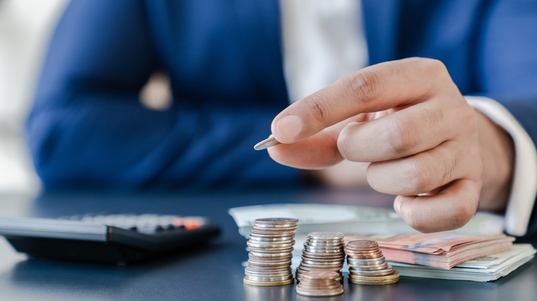 Businessperson stacking coins