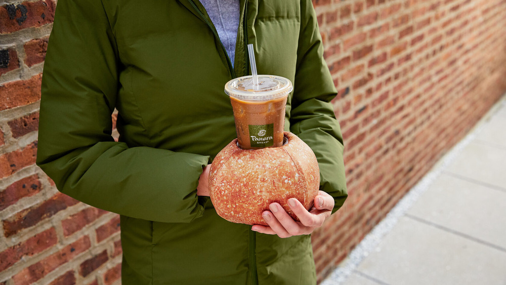 Person using bread bowl as glove