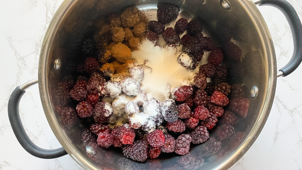 berries in saucepan with sugar and cinnamon for blackberry cobbler