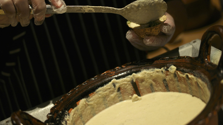 person cooking mole blanco