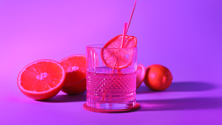 a cocktail surrounded by oranges