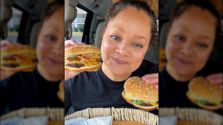 TikToker Ashley Smith holding a kids cheeseburger and a Whopper Jr. from Burger King.