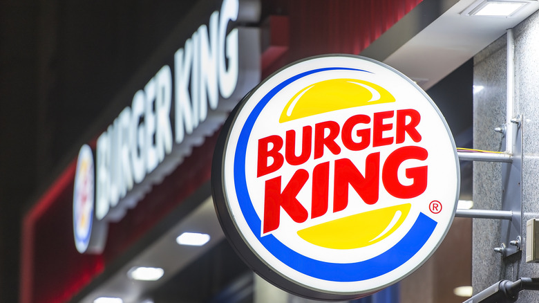 Burger King logo in front of a Burger King restaurant sign