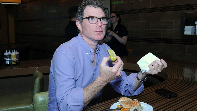 Bobby Flay holding pickle