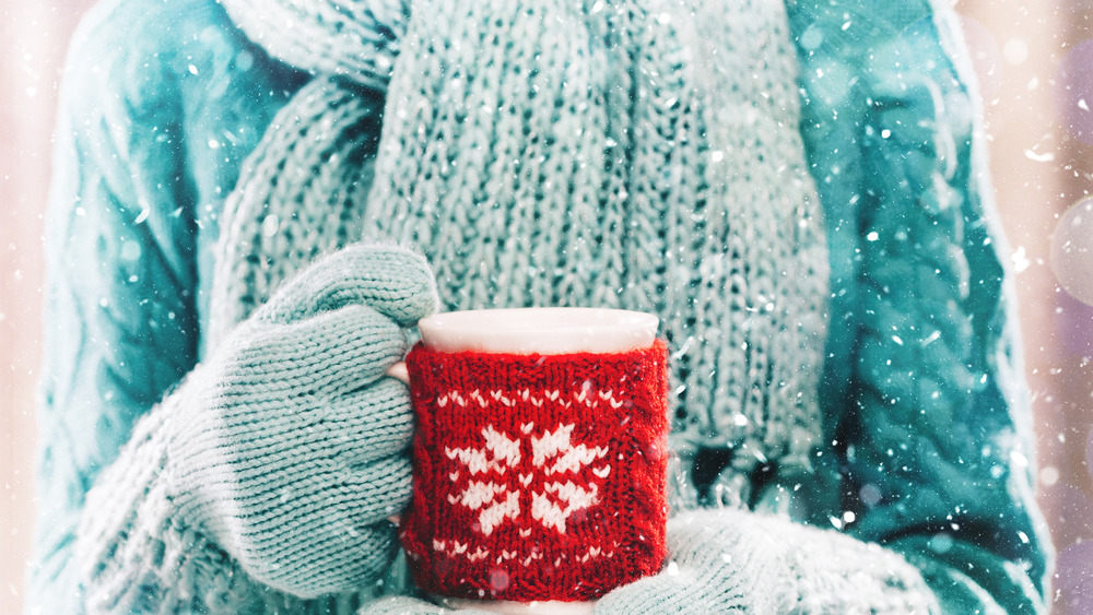 A woman holding a cup of coffee