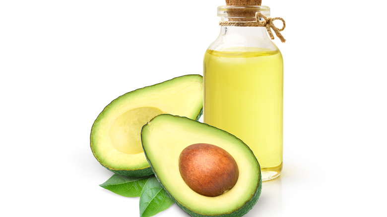 Avocado with bottle of oil