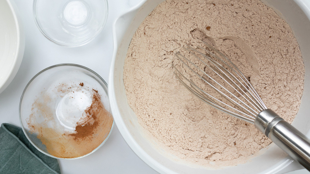 Sugar, flour in bowl with whisk