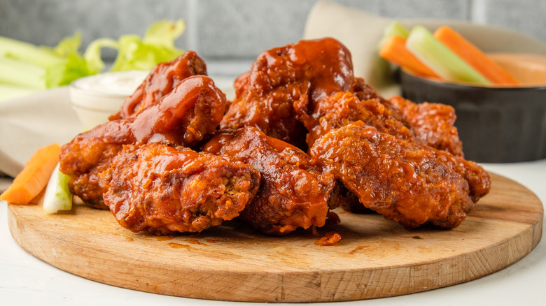 buffalo chicken wings on wooden plate with celery