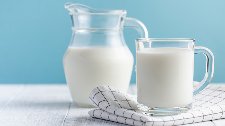 milk in clear glass containers and blue background