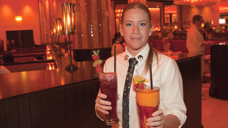 Cheesecake Factory server holding cocktails