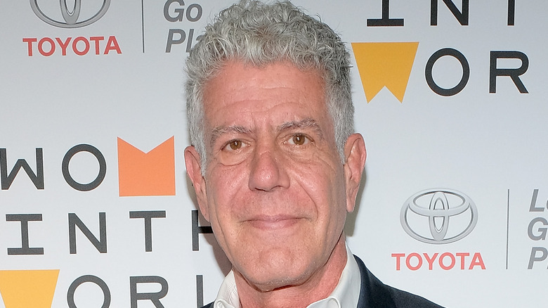 Close-up of Anthony Bourdain smirking