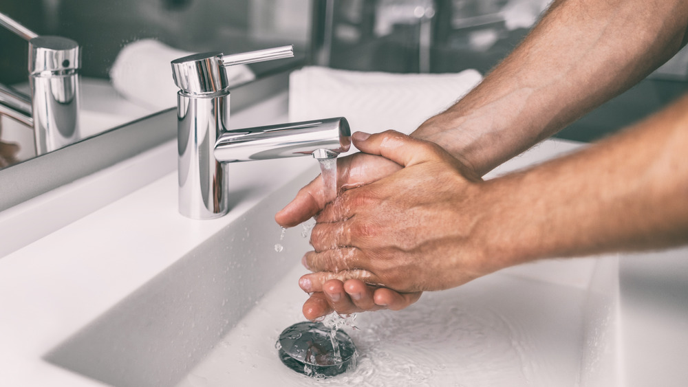 Washing hands in sink