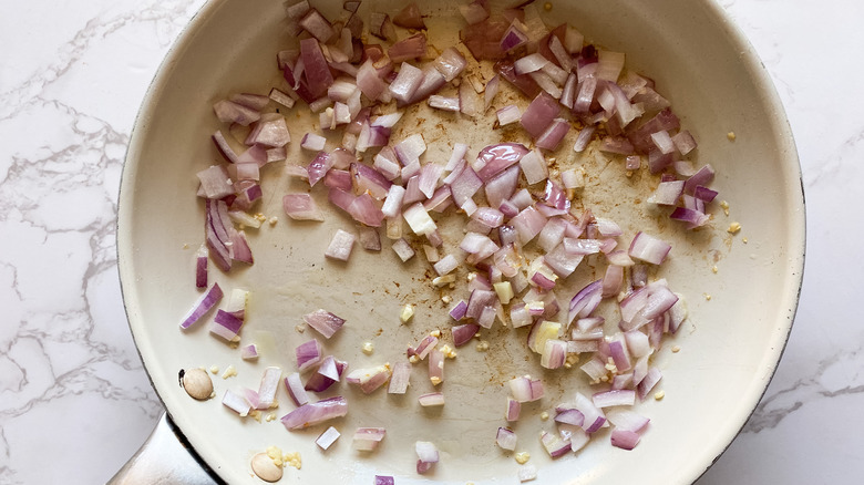 A skillet with sautéed onion and garlic 