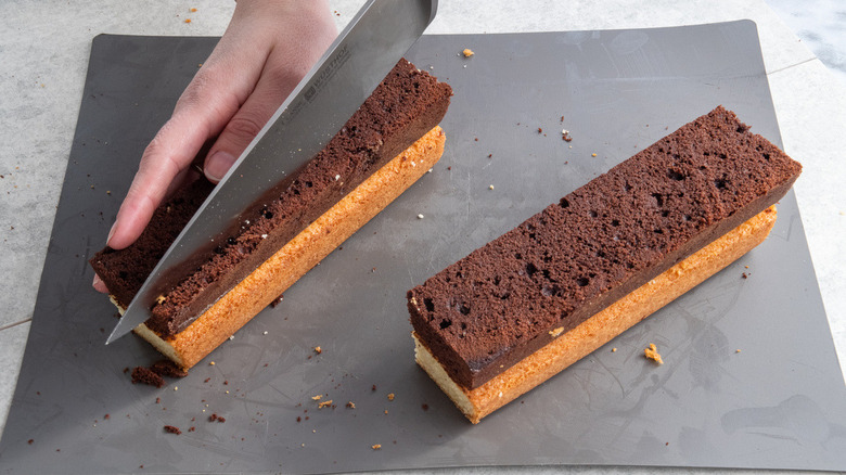 Slicing chocolate and white cakes