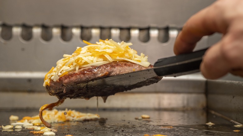 ground beef and cheese on griddle