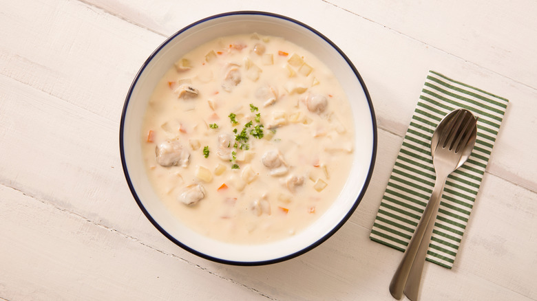 Clam chowder in a bowl on a table 