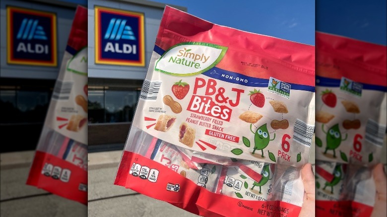 Someone holding up a bag of PB&J bites outside of Aldi