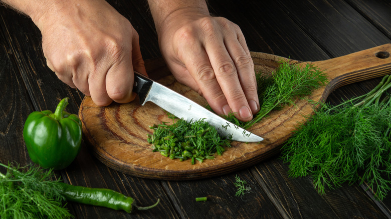 chopping fresh dill and chives