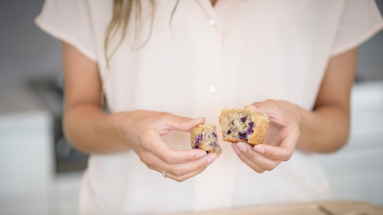 Woman holding blueberry muffin