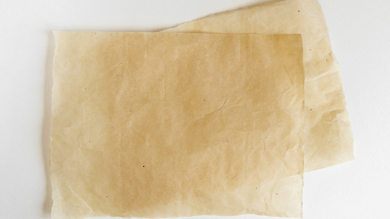 Sheets of parchment paper on a white background