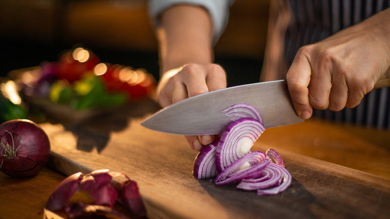 Chef chopping red onions