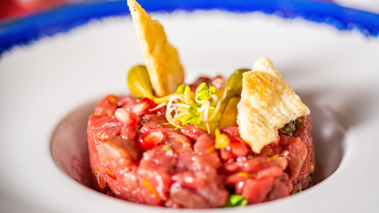 Donkey tartare with pomegranate seeds