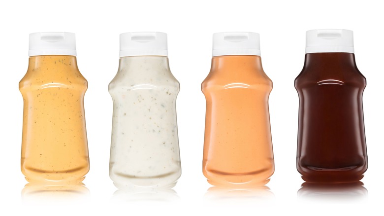 four bottles of squeezable sauces