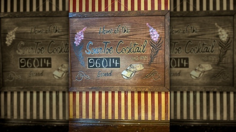 Sign showing how many people have had sourtoe cocktails