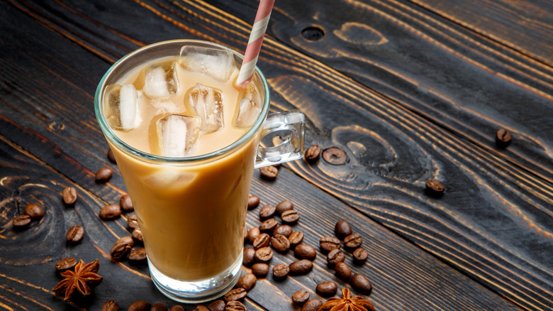 iced coffee in glass with paper straw