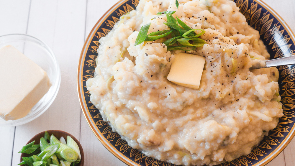 colcannon in bowl with butter and green onion