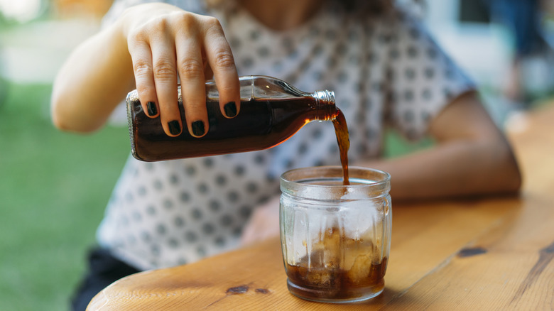 Person pouring cold brew into glass