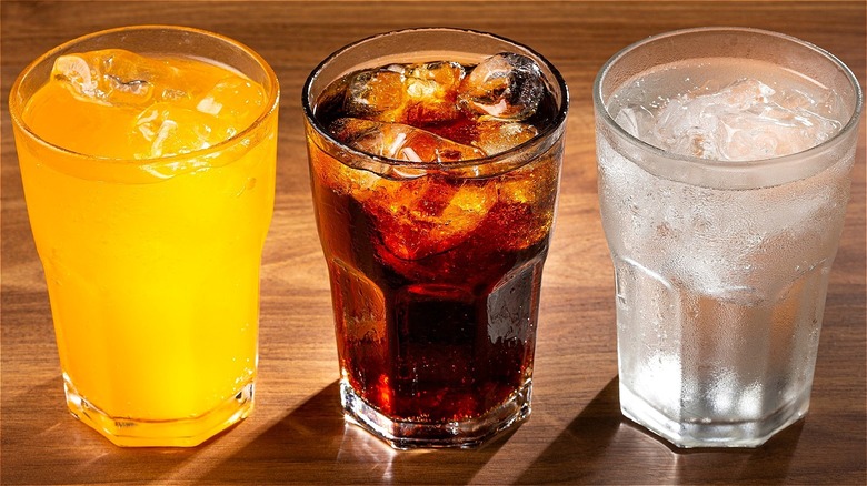 Three ice-cold drinks in clear glasses