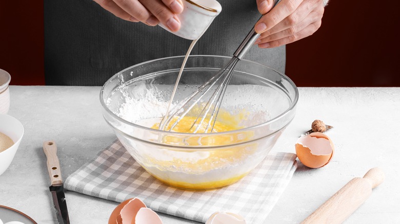 Person pouring milk into bowl